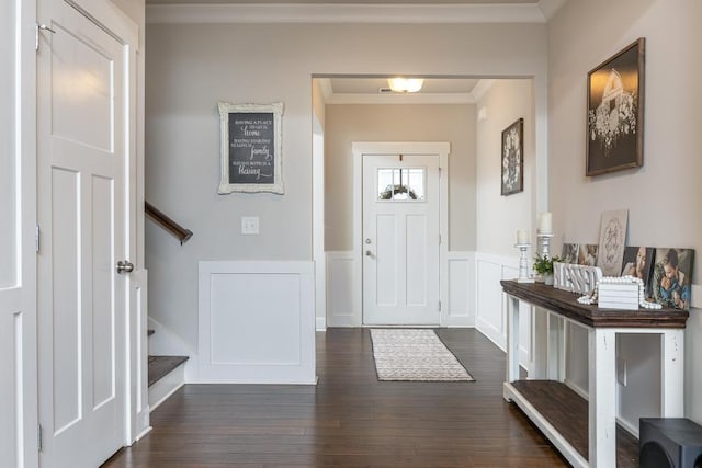 foyer entrance with dark wood-type flooring and crown molding