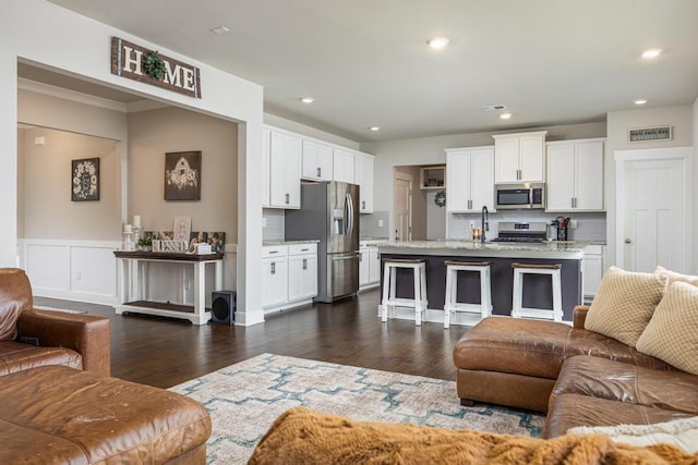 living room with dark wood-type flooring and sink