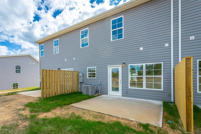 back of property with a patio area and central AC