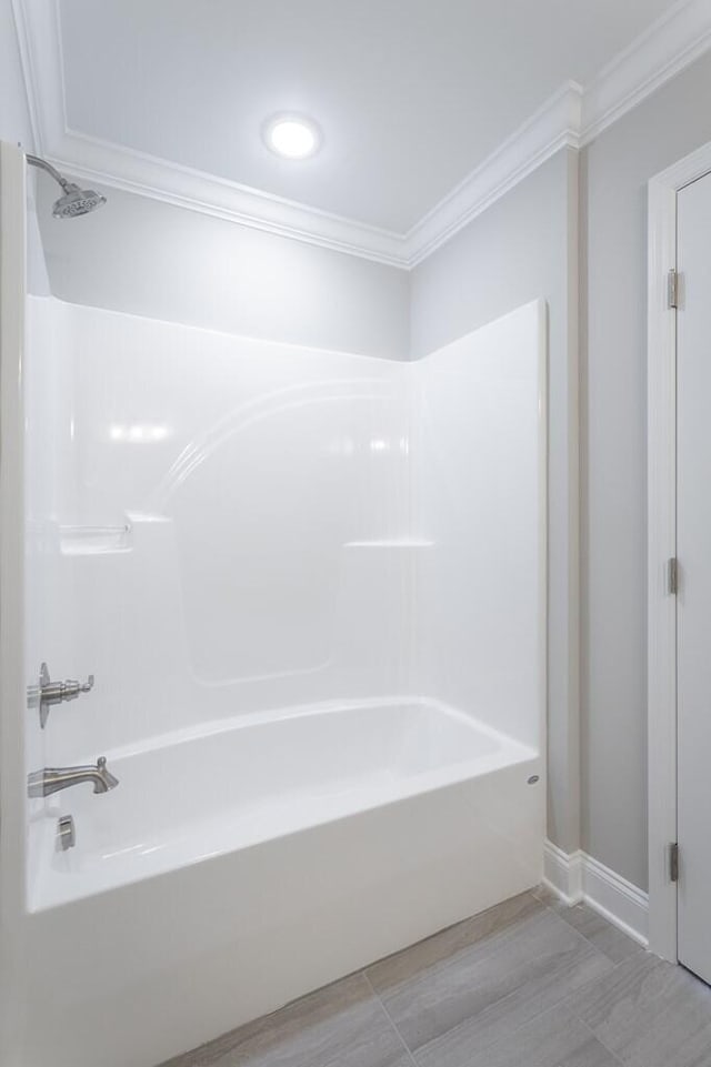 bathroom with ornamental molding and bathtub / shower combination