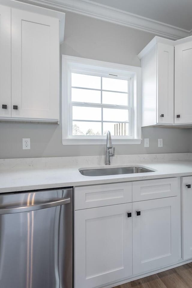 kitchen featuring dishwasher, dark hardwood / wood-style flooring, white cabinets, ornamental molding, and sink