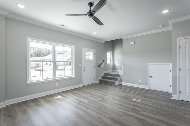 unfurnished living room featuring ceiling fan, dark wood-type flooring, and ornamental molding