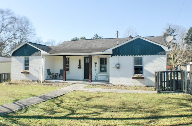 single story home with covered porch and a front lawn