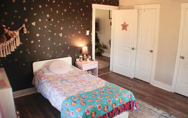 bedroom with dark hardwood / wood-style flooring