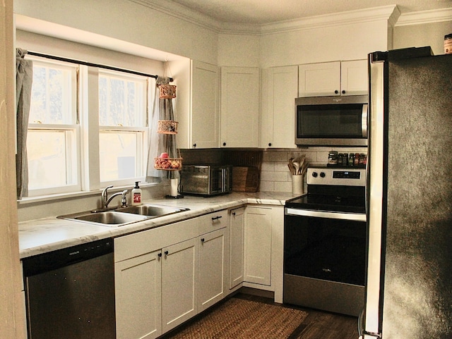 kitchen featuring stainless steel appliances, white cabinetry, dark hardwood / wood-style floors, and sink