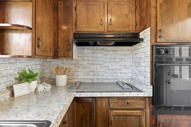 kitchen with decorative backsplash and black appliances