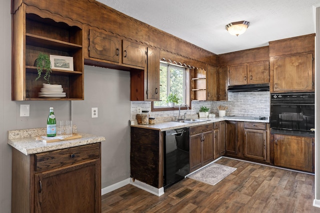 kitchen featuring light stone counters, sink, dark hardwood / wood-style floors, and black appliances