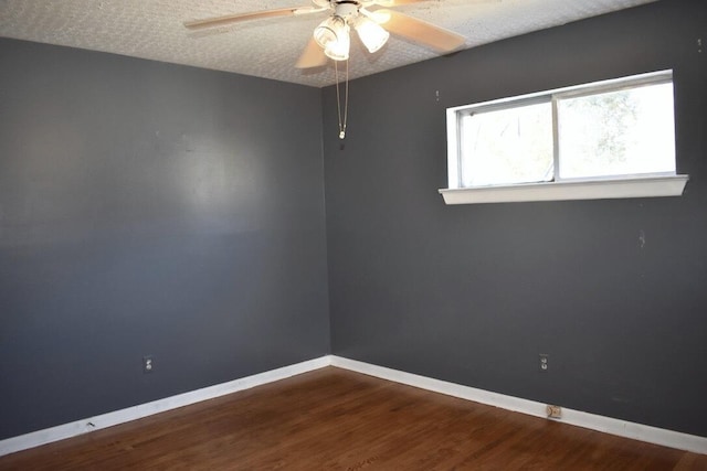 empty room with ceiling fan, a textured ceiling, and hardwood / wood-style floors