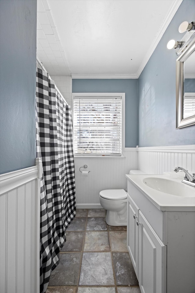 bathroom featuring crown molding, vanity, and toilet