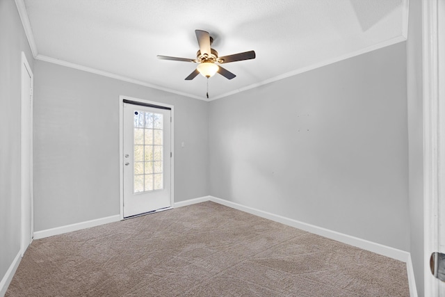 carpeted empty room featuring ceiling fan and crown molding