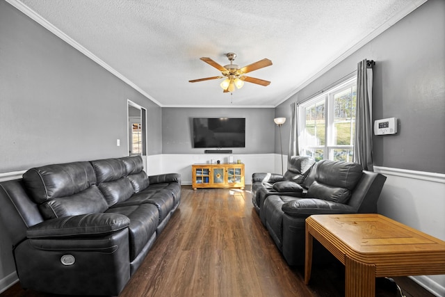 living room with a textured ceiling, ceiling fan, crown molding, and dark hardwood / wood-style floors