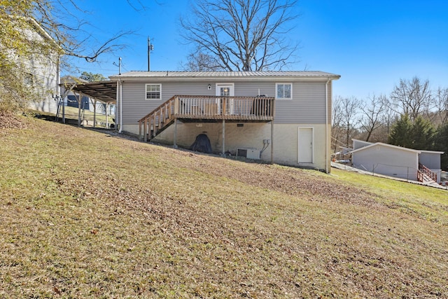 rear view of house featuring a deck and a lawn