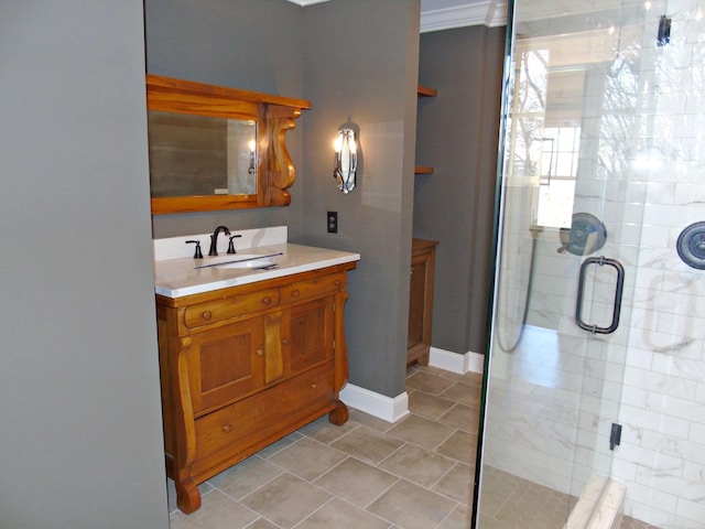 full bath with a stall shower, vanity, and baseboards