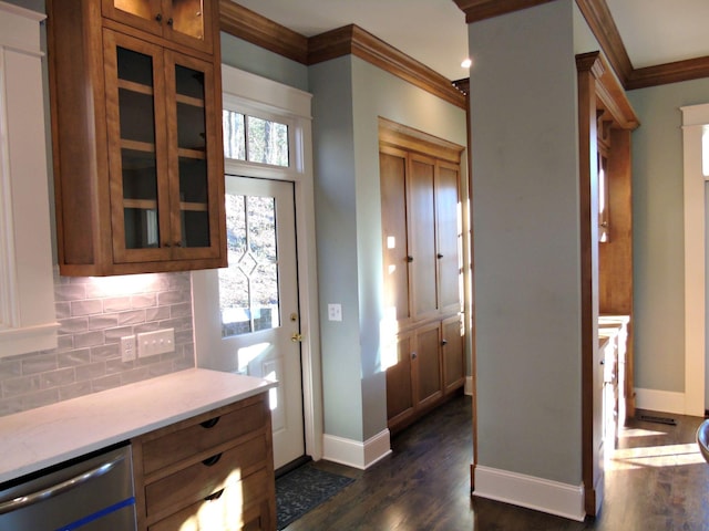 kitchen with tasteful backsplash, baseboards, dark wood-style flooring, crown molding, and stainless steel dishwasher