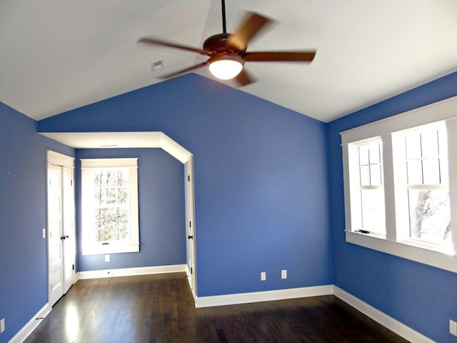 spare room with ceiling fan, baseboards, vaulted ceiling, and wood finished floors