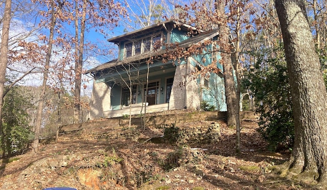 rear view of house with covered porch