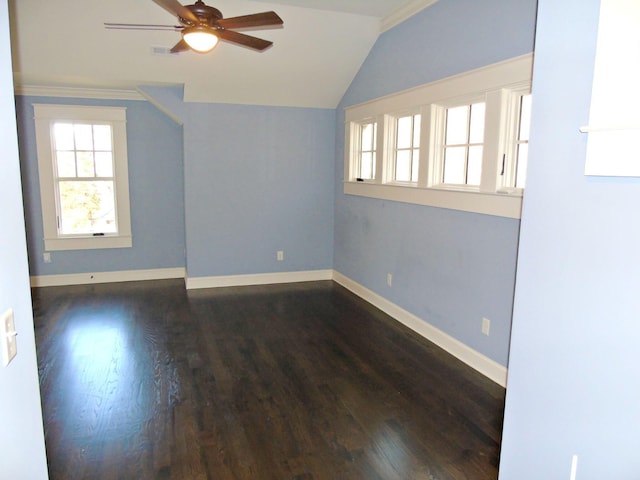 spare room featuring a ceiling fan, baseboards, vaulted ceiling, and dark wood finished floors