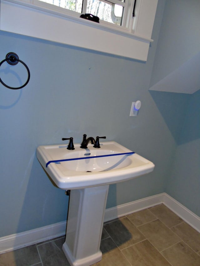 bathroom with tile patterned flooring and baseboards