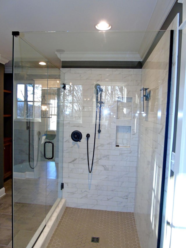 full bath featuring a stall shower and crown molding