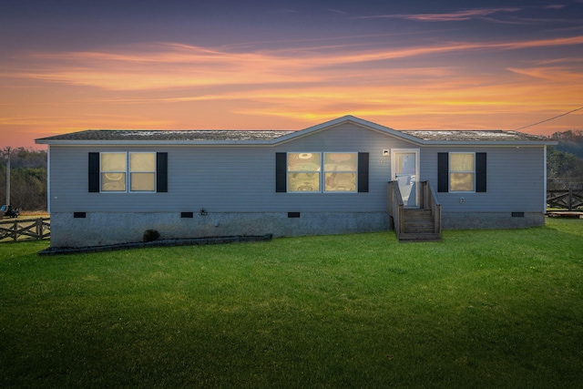 view of front of property with a lawn