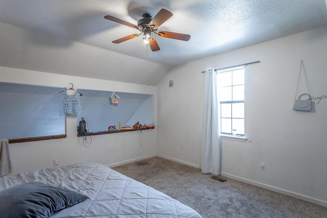 carpeted bedroom featuring ceiling fan, a textured ceiling, and lofted ceiling