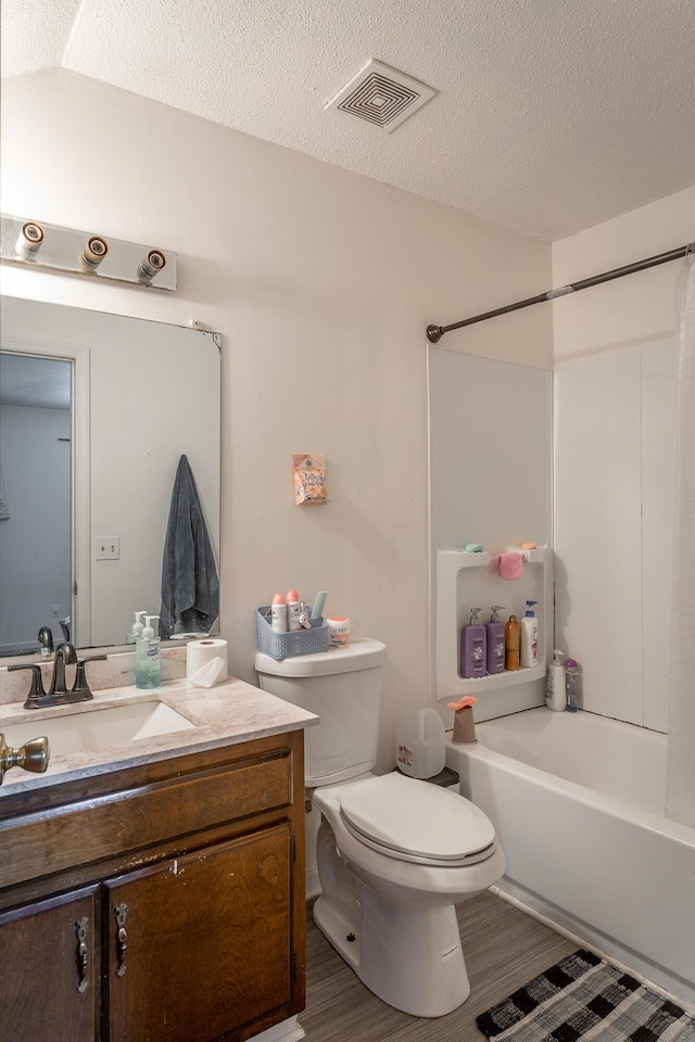 full bathroom featuring vanity, a textured ceiling, and hardwood / wood-style floors