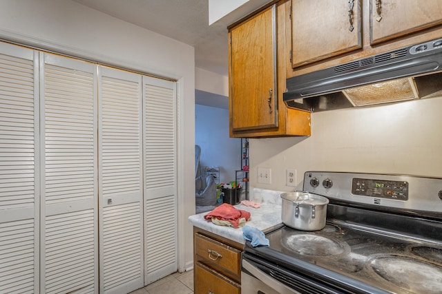 kitchen with light tile patterned floors and electric stove