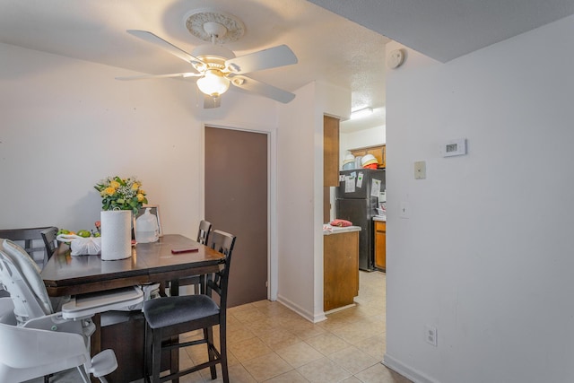 tiled dining room featuring ceiling fan