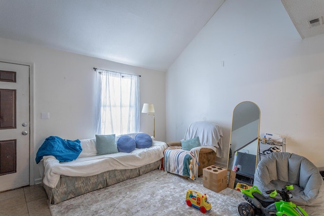 living room featuring lofted ceiling and tile patterned flooring