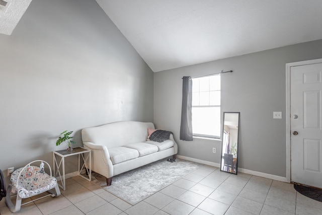 sitting room featuring lofted ceiling and light tile patterned floors