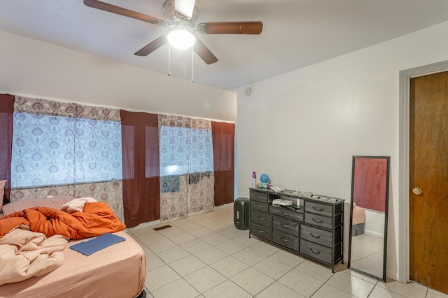 bedroom with ceiling fan and light tile patterned floors