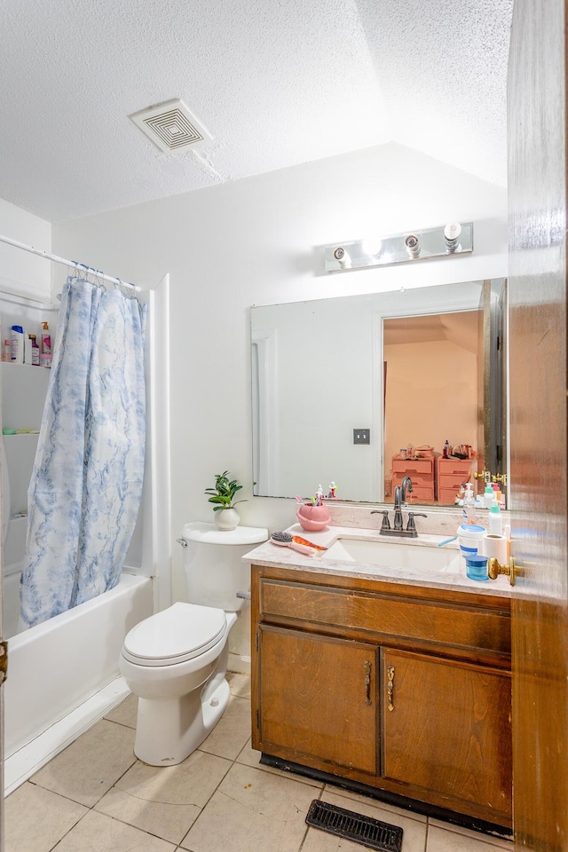 full bathroom featuring toilet, tile patterned flooring, shower / tub combo, a textured ceiling, and vanity