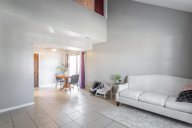 living room with ceiling fan and light tile patterned flooring