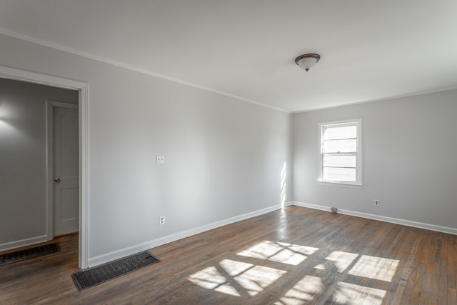 unfurnished room featuring dark hardwood / wood-style floors and ornamental molding