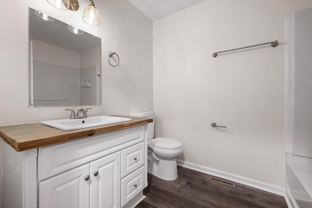 bathroom featuring toilet, wood-type flooring, and vanity