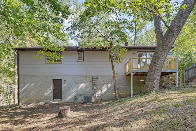 back of house featuring a deck and cooling unit