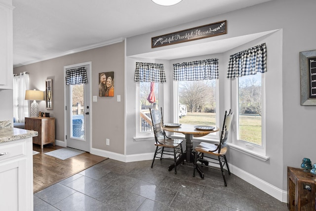 dining room featuring baseboards and ornamental molding