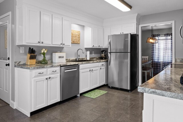 kitchen featuring appliances with stainless steel finishes, a sink, white cabinetry, and ornamental molding