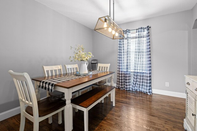 dining area with wood finished floors and baseboards