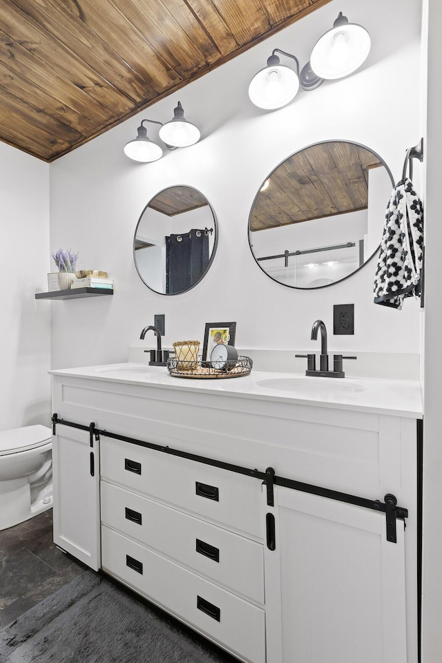 bathroom with toilet, wood ceiling, and double vanity