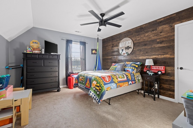 carpeted bedroom with wooden walls, ceiling fan, vaulted ceiling, and baseboards