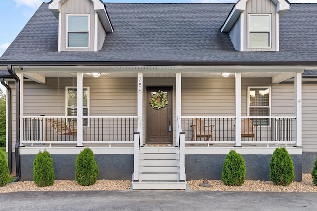 view of front of home with covered porch and a shingled roof