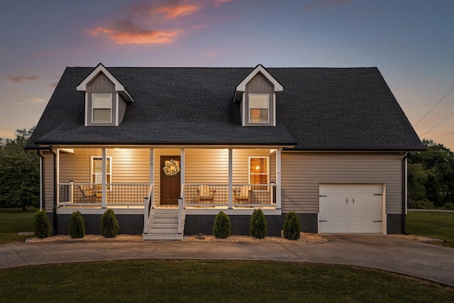 cape cod home featuring a porch, driveway, and a front yard