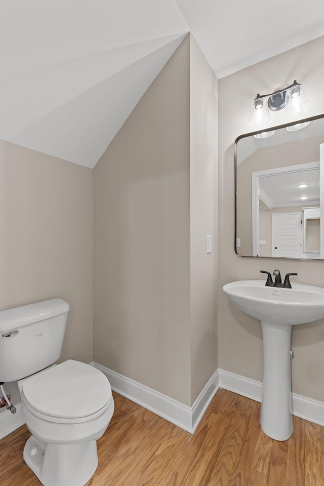 bathroom with toilet and hardwood / wood-style floors