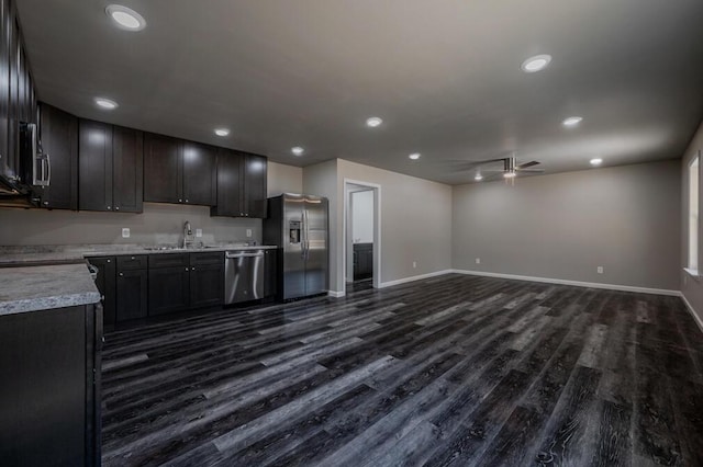 kitchen featuring a sink, dark wood-style floors, appliances with stainless steel finishes, light countertops, and ceiling fan