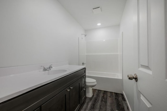 full bath featuring tub / shower combination, toilet, vanity, and wood finished floors