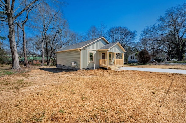 view of front facade with crawl space, roof with shingles, and covered porch