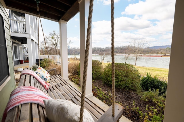 balcony with a water view and a porch