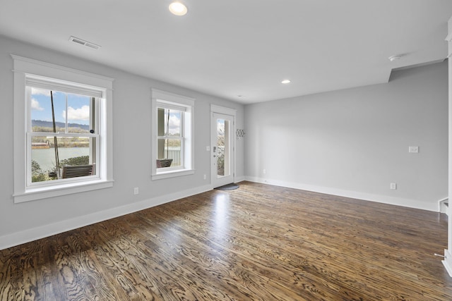 spare room with dark hardwood / wood-style floors