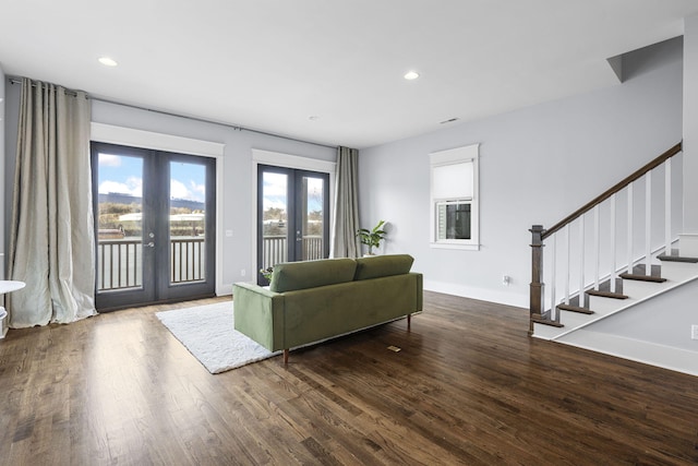 living room featuring dark hardwood / wood-style flooring and french doors